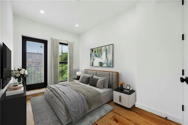 a bedroom with a bed and a large window