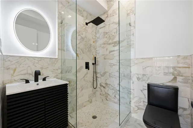 a bathroom with a sink a mirror and a shower