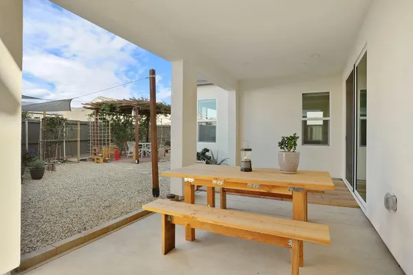 a view of a chairs and table in patio