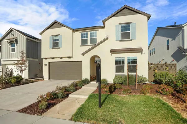 a front view of a house with a yard