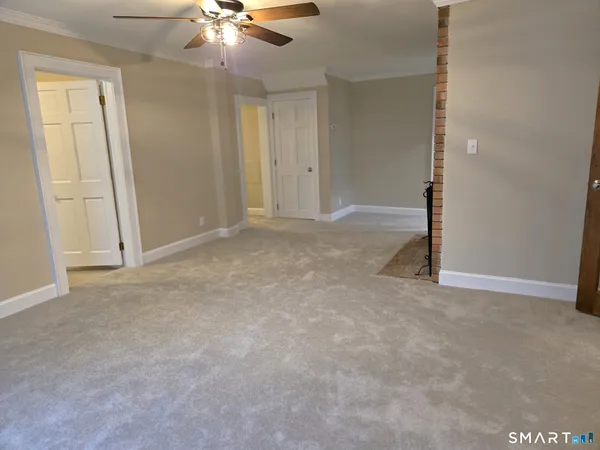 an empty room with closet and chandelier fan