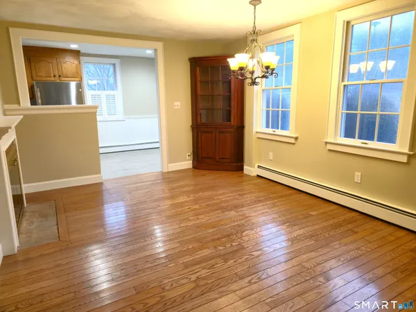 a view of a room with wooden floor and window
