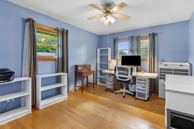 a view of a livingroom with workspace and a window