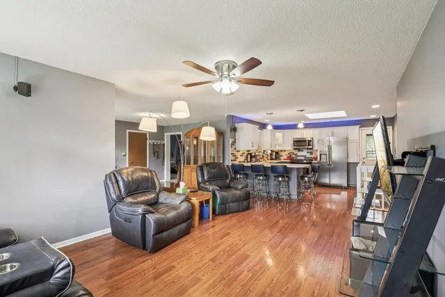 a living room with furniture and wooden floor