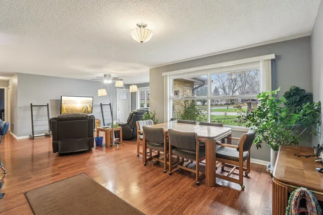a view of a dining room with furniture window and wooden floor