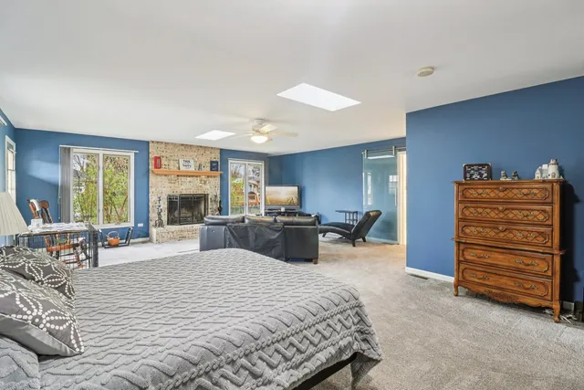 a bedroom with furniture and a large window