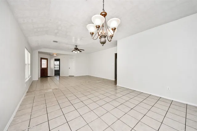 a view of a chandelier fan and kitchen view