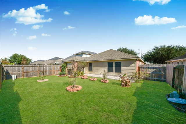 an aerial view of a house with outdoor space and parking