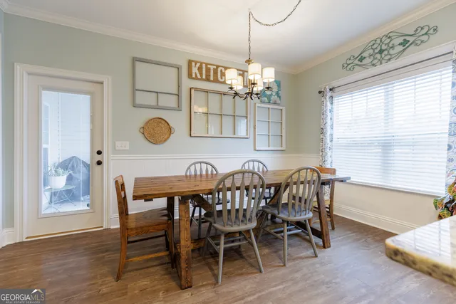 a view of a dining room with furniture and chandelier
