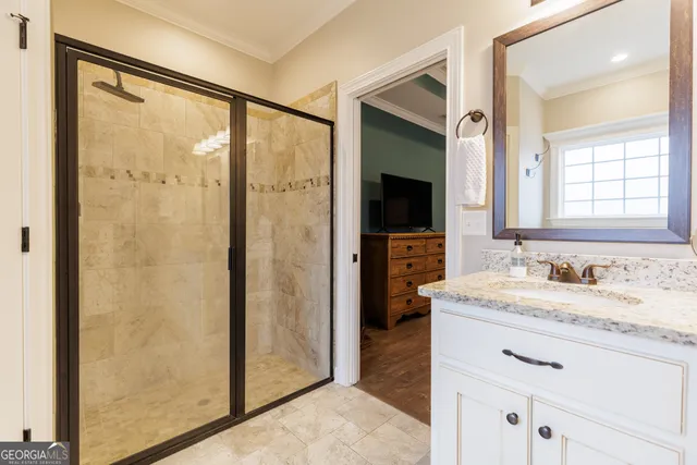 a bathroom with a granite countertop sink mirror and a shower