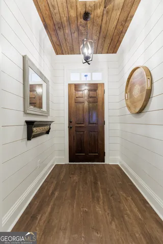 a view of a hallway with wooden floor