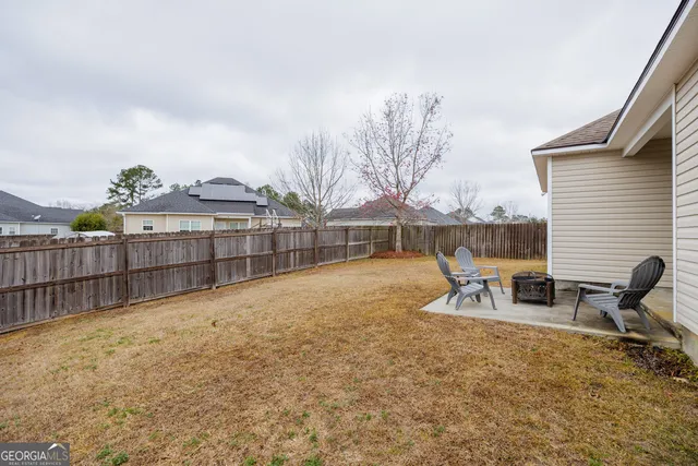 a view of a backyard with chairs