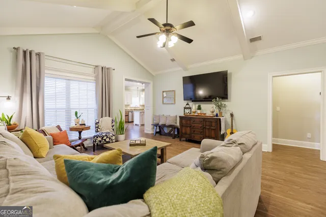 a living room with furniture a fireplace and a flat screen tv