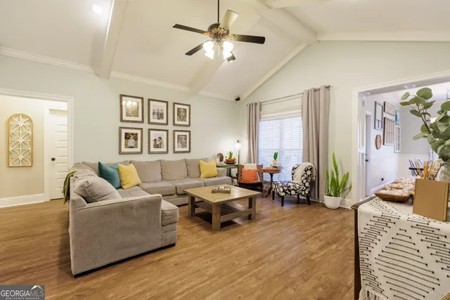 a living room with furniture and wooden floor