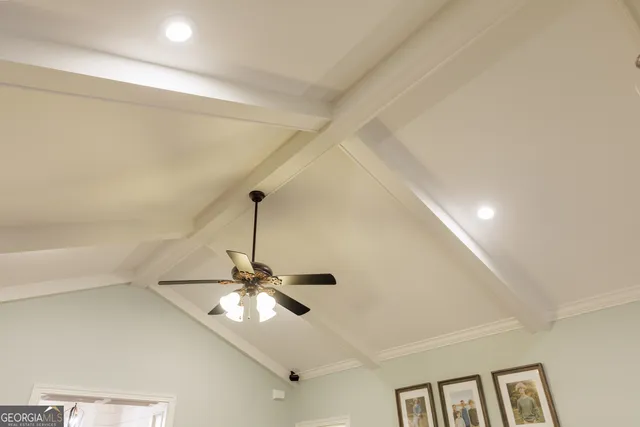 a view of a room with a ceiling fan