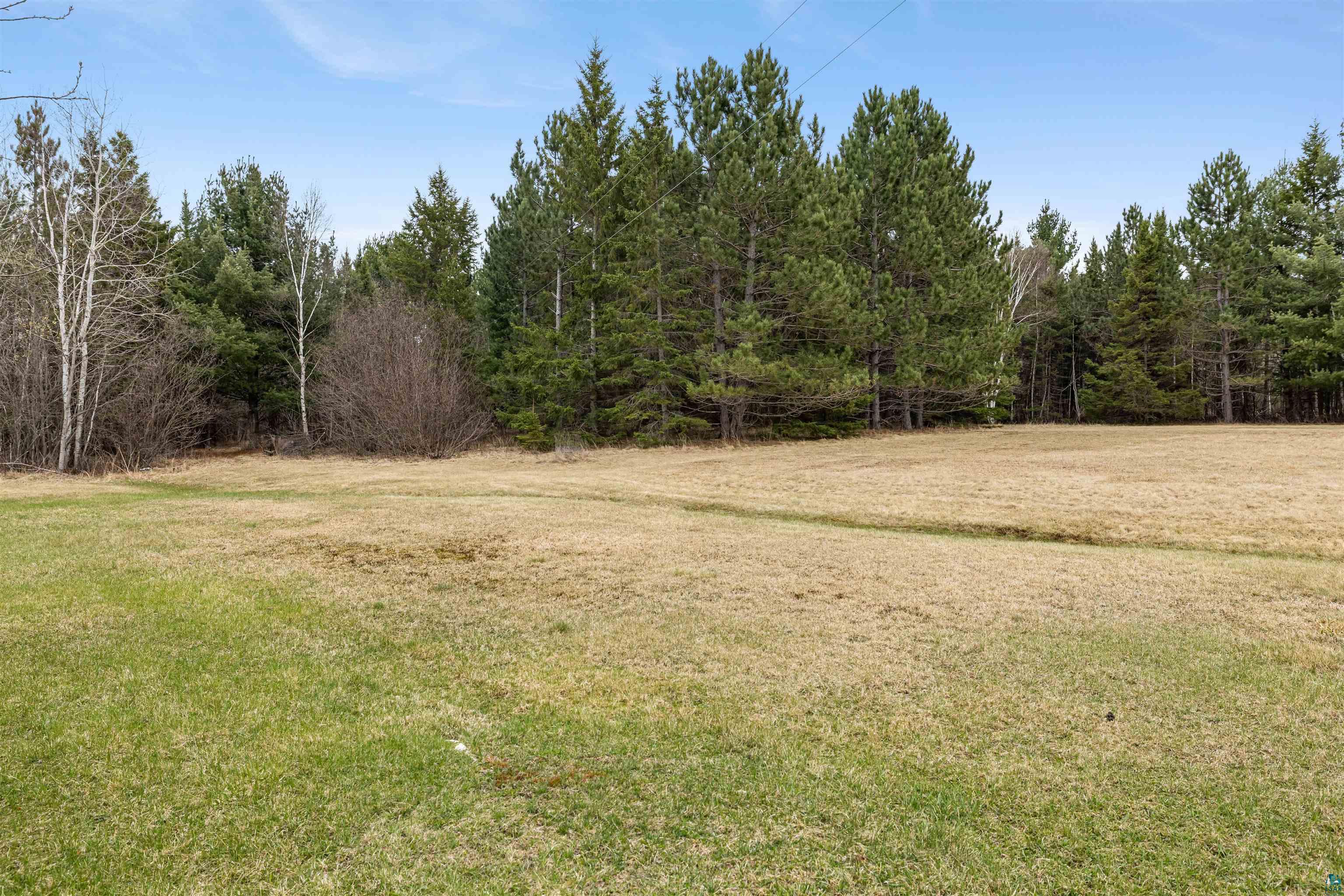 11574 Town Line Road Hibbing, MN 55746 - Photo 32 of 41 Expansive open field with a mix of green and dormant grass