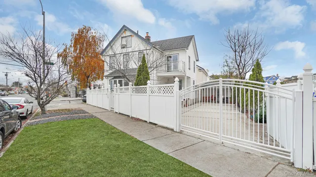 a view of a house with a small yard and deck