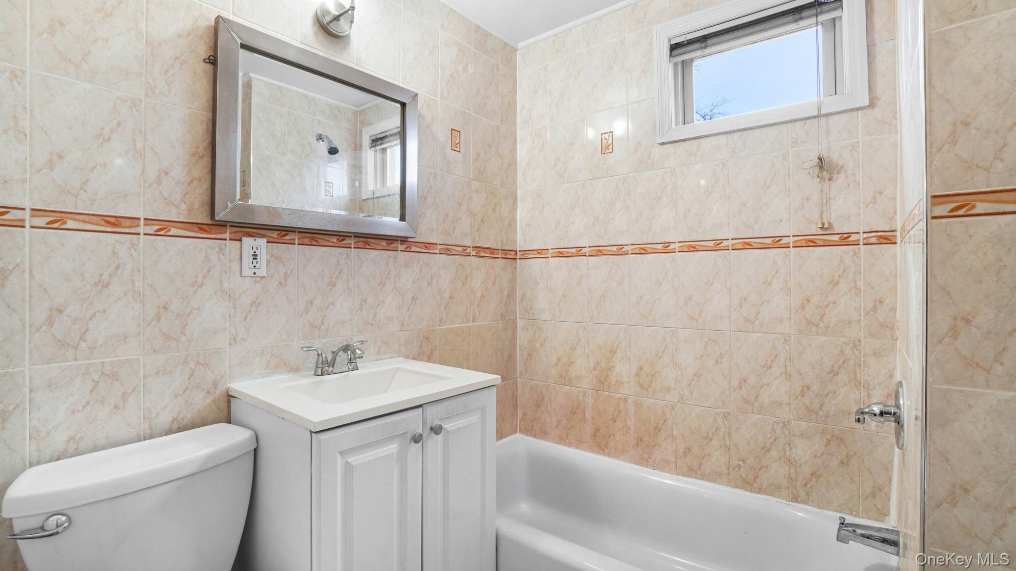 217-34 Hempstead Avenue Queens, NY 11429 - Photo 12 of 21 a bathroom with a sink mirror and toilet