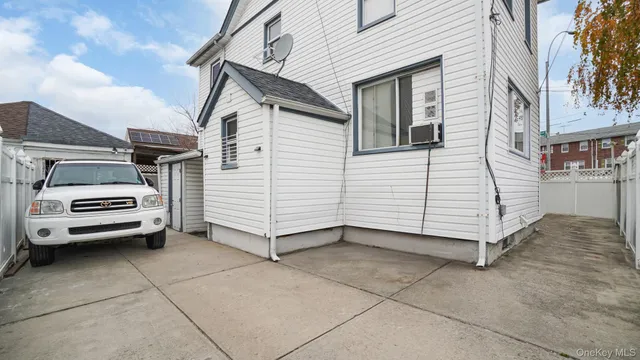a view of a white house with a yard