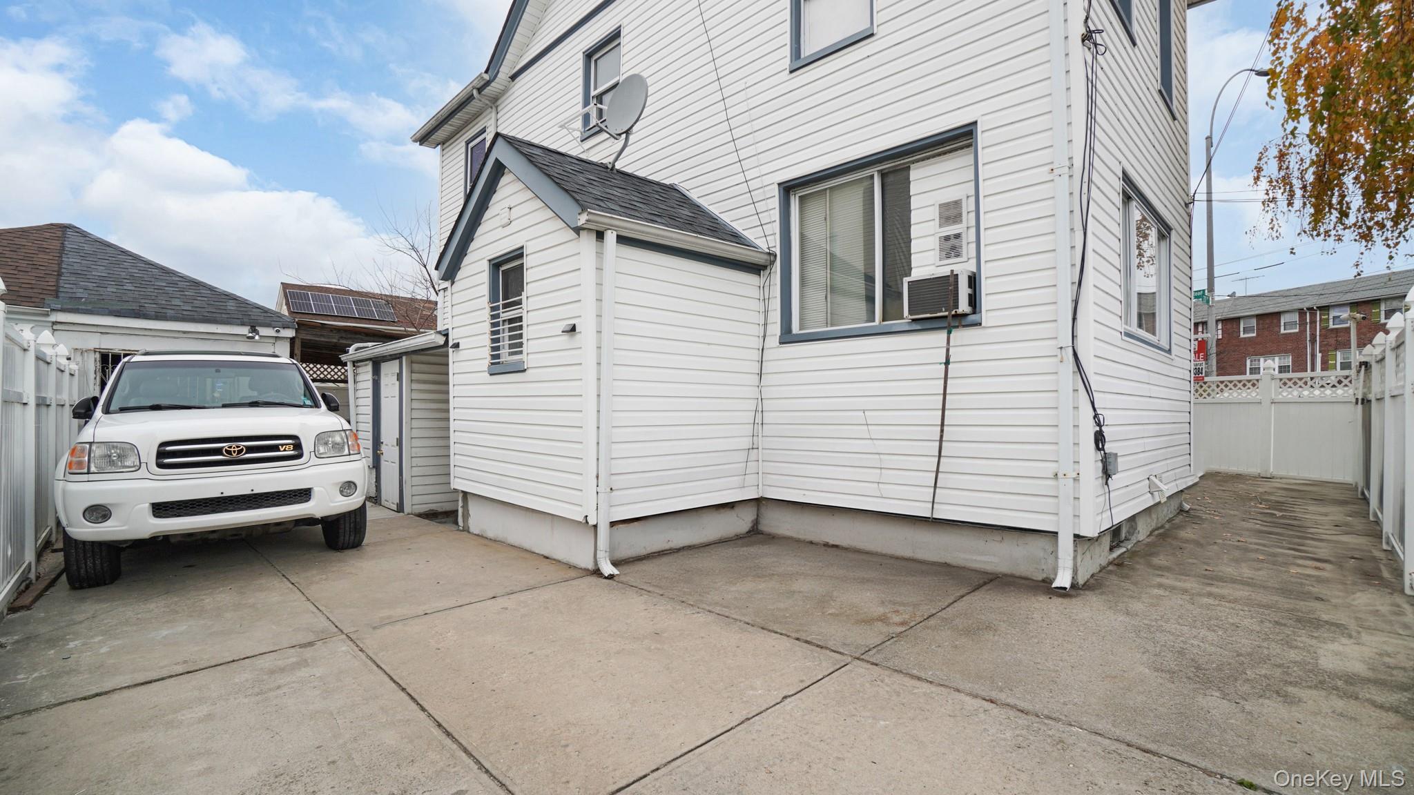 217-34 Hempstead Avenue Queens, NY 11429 - Photo 5 of 21 a view of a white house with a yard
