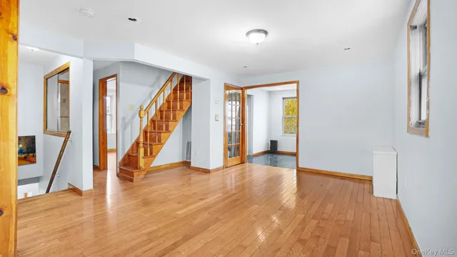 a view of an entryway with wooden floor