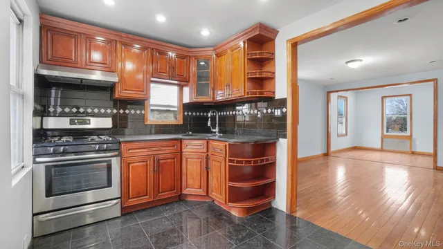 a kitchen with stainless steel appliances granite countertop a stove and a sink