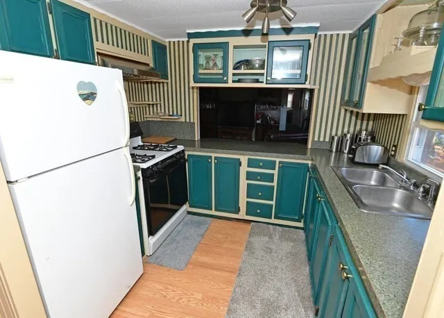 a kitchen with a refrigerator and a sink