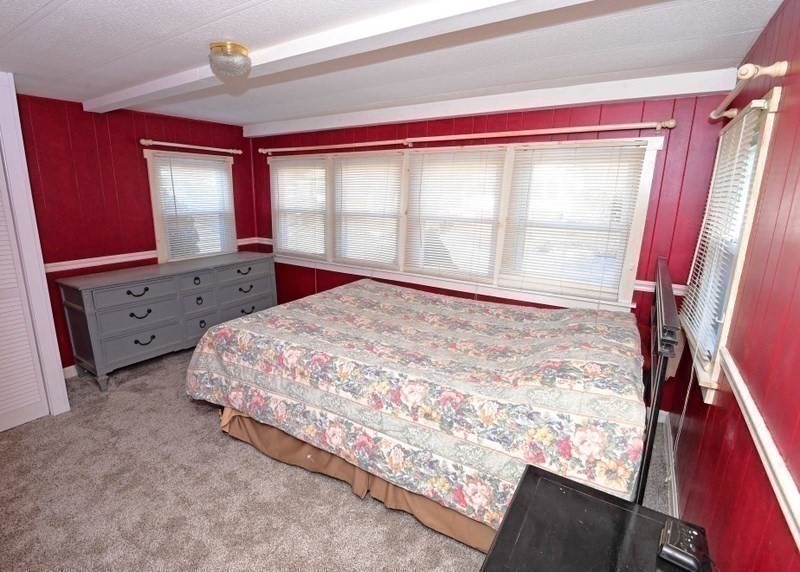 103 Castle Drive Wareham, MA 02576 - Photo 15 of 22 a large bed sitting in a bedroom next to a window