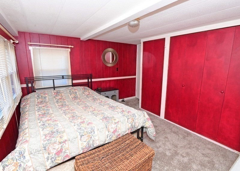 103 Castle Drive Wareham, MA 02576 - Photo 16 of 22 a bedroom with a bed and a mirror