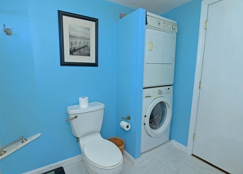103 Castle Drive Wareham, MA 02576 - Photo 21 of 22 a white toilet sitting next to a bathroom sink