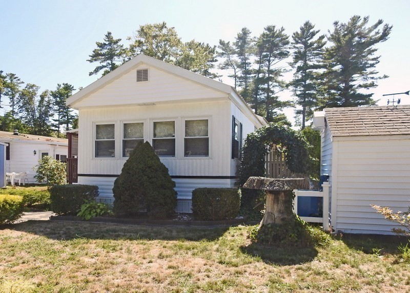 103 Castle Drive Wareham, MA 02576 - Photo 5 of 22 a view of a white house with a yard