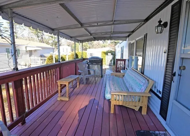 a view of a balcony with furniture and wooden floor