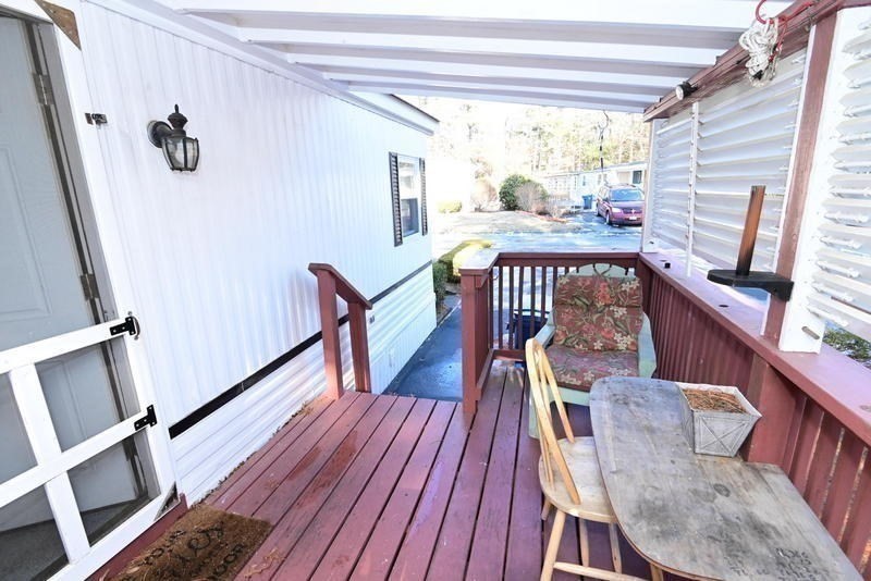 103 Castle Drive Wareham, MA 02576 - Photo 7 of 22 a view of a porch with wooden floor and furniture