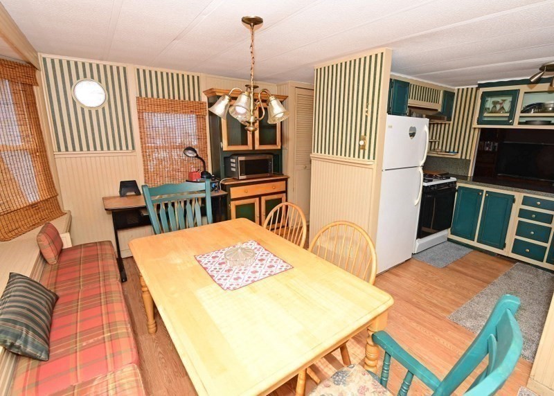 103 Castle Drive Wareham, MA 02576 - Photo 9 of 22 a dinning room with furniture a rug and wooden floor