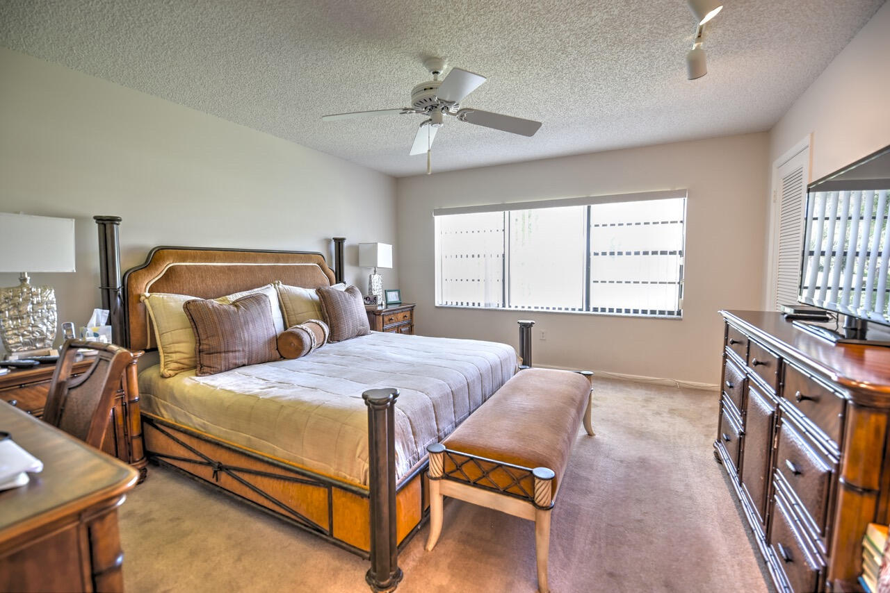 28 Stratford Lane West, Unit C Boynton Beach, FL 33436 - Photo 14 of 25 a bedroom with a bed and window