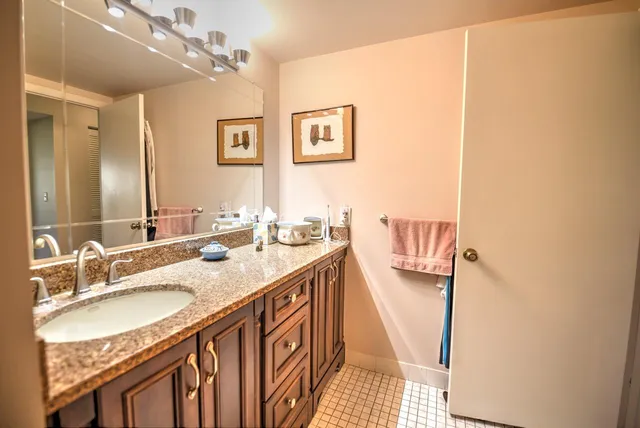 a bathroom with a sink double vanity granite and a mirror