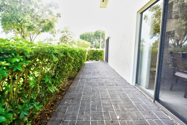 a view of a pathway with a yard