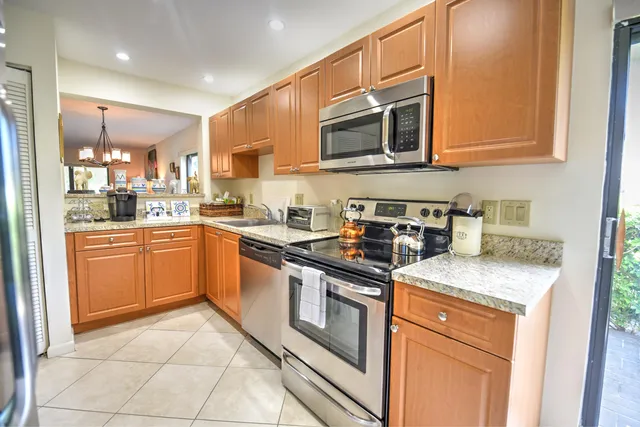 a kitchen with stainless steel appliances granite countertop a sink and cabinets