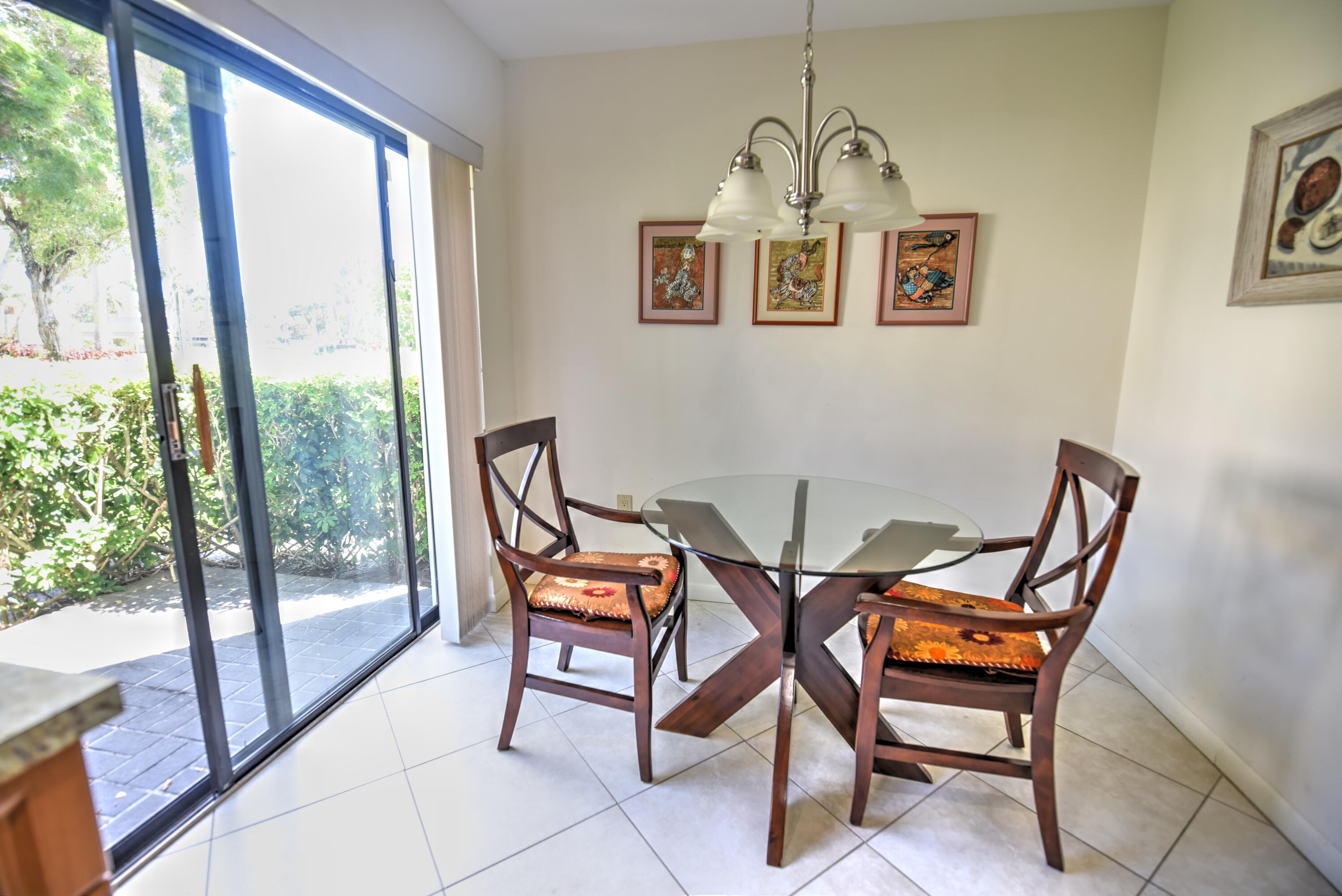 28 Stratford Lane West, Unit C Boynton Beach, FL 33436 - Photo 6 of 25 a view of a dining room with furniture window and outside view