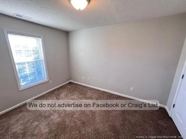 a bathroom with a granite countertop sink mirror vanity and toilet