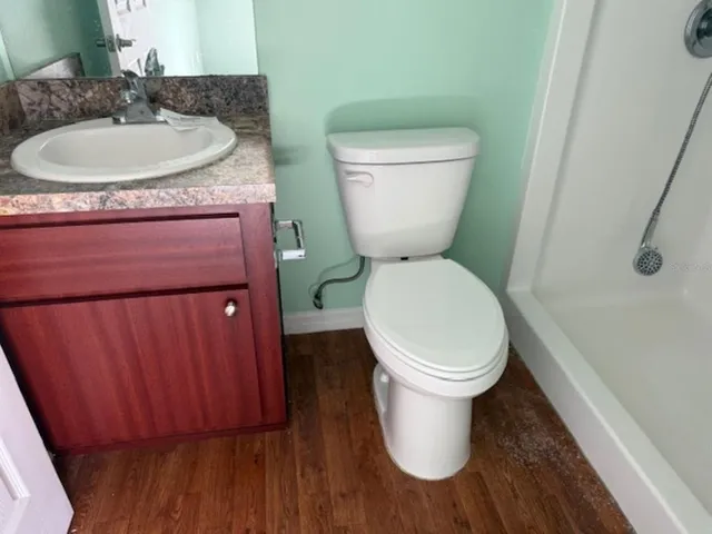 a white toilet sitting next to a bathroom sink