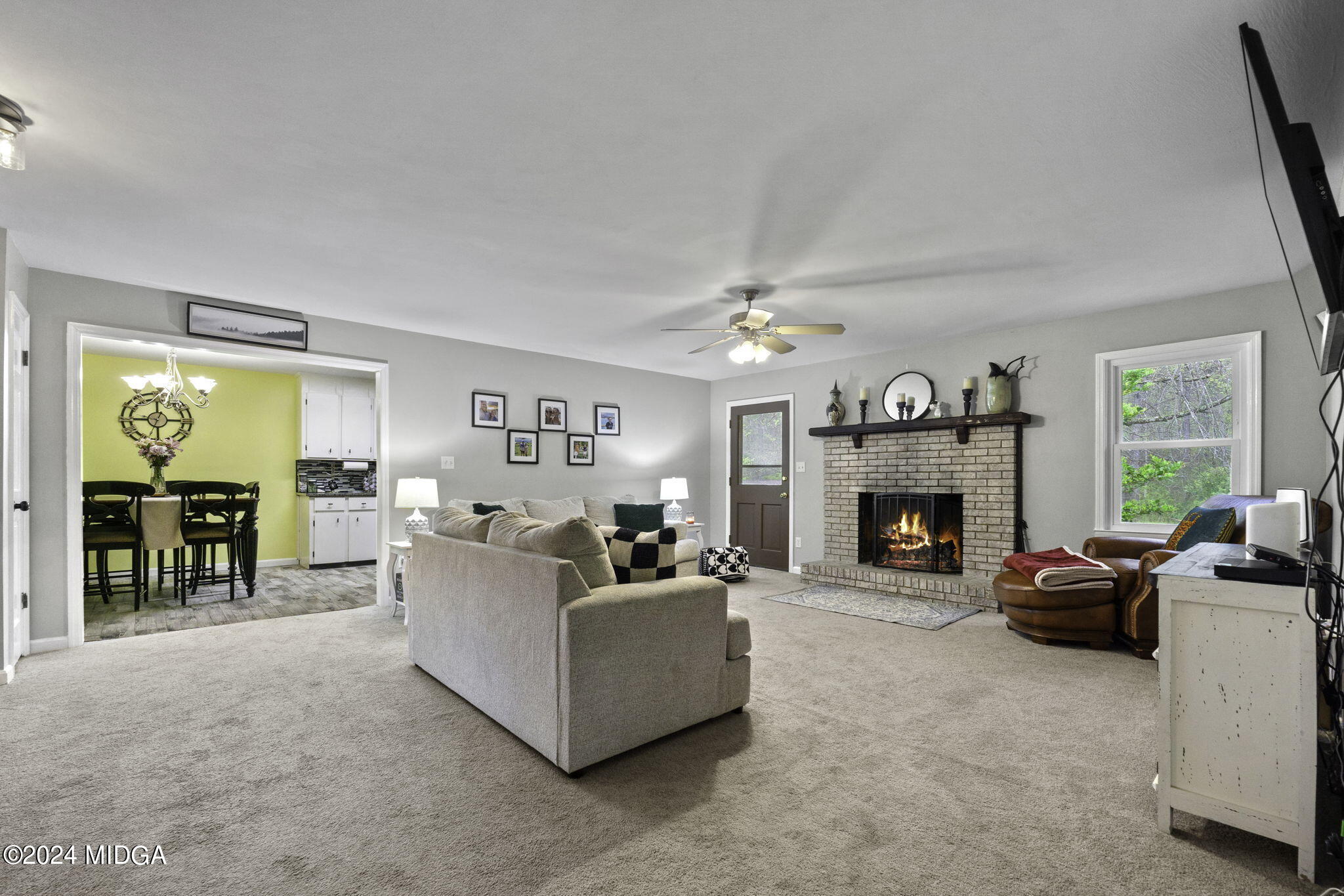 1299 Rainey Road Macon, GA 31220 - Photo 11 of 35 a living room with furniture a fireplace and a flat screen tv
