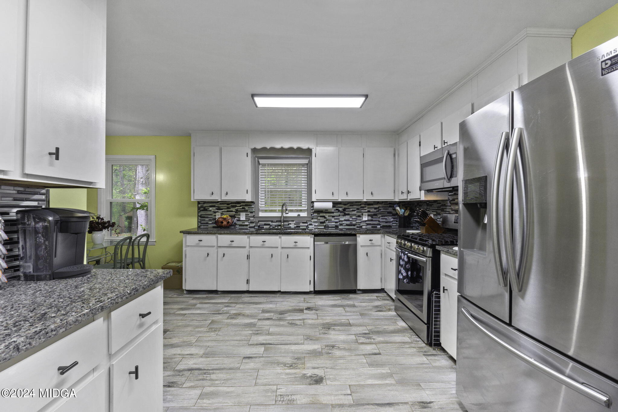 1299 Rainey Road Macon, GA 31220 - Photo 14 of 35 a kitchen with granite countertop a refrigerator stove top oven and sink