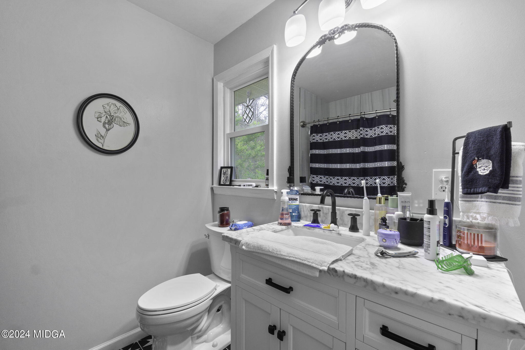 1299 Rainey Road Macon, GA 31220 - Photo 20 of 35 a bathroom with a granite countertop toilet sink and mirror