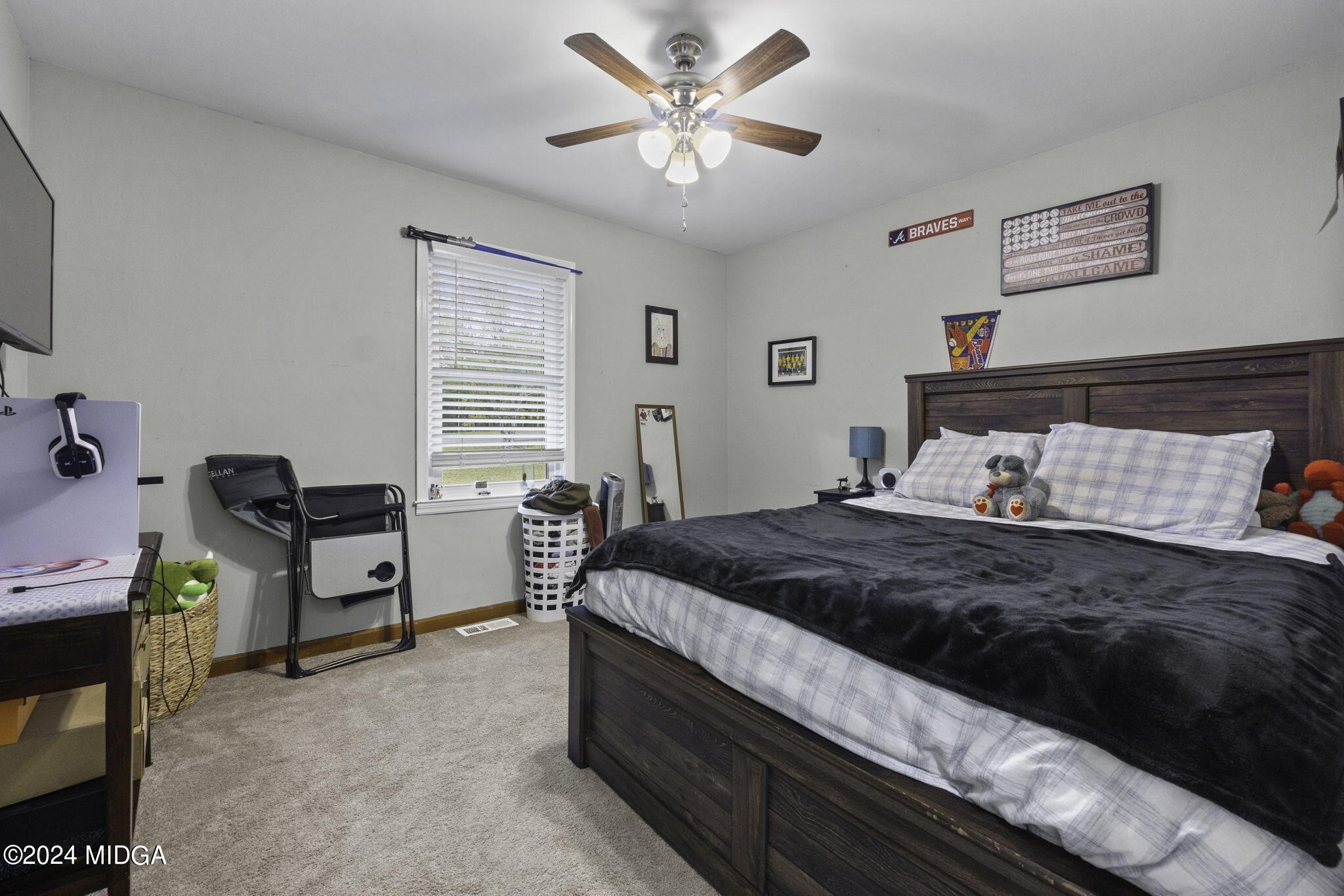 1299 Rainey Road Macon, GA 31220 - Photo 22 of 35 a bedroom with a bed and a chandelier