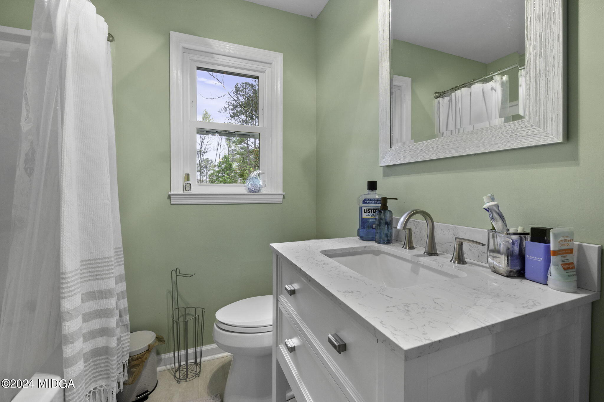 1299 Rainey Road Macon, GA 31220 - Photo 24 of 35 a bathroom with a toilet sink and mirror