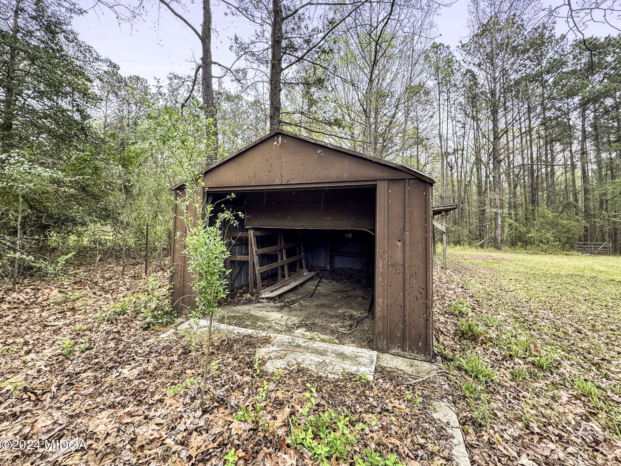 1299 Rainey Road Macon, GA 31220 - Photo 26 of 35 a view of a wooden house with a yard