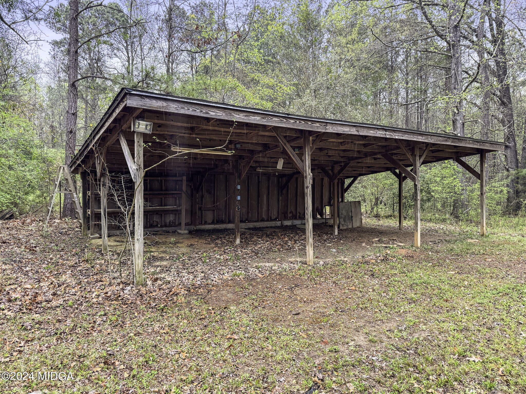 1299 Rainey Road Macon, GA 31220 - Photo 27 of 35 a view of a wooden house with a large tree