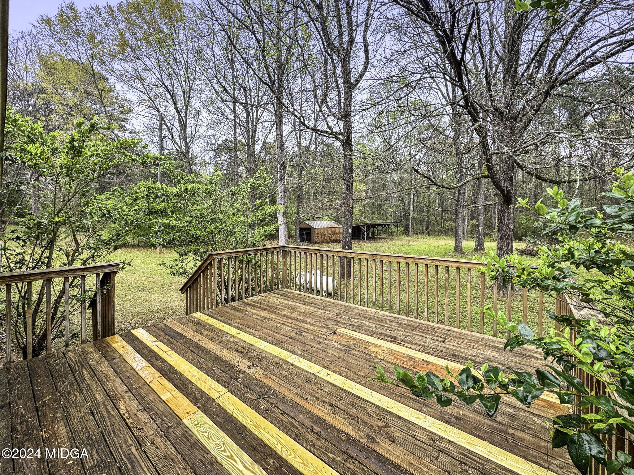 1299 Rainey Road Macon, GA 31220 - Photo 30 of 35 a view of a balcony with wooden floor and trees