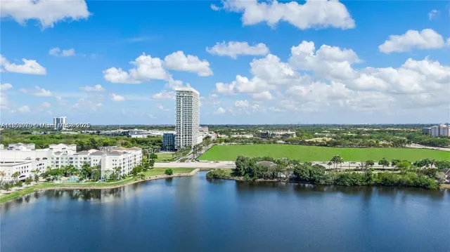 a view of a city with tall trees